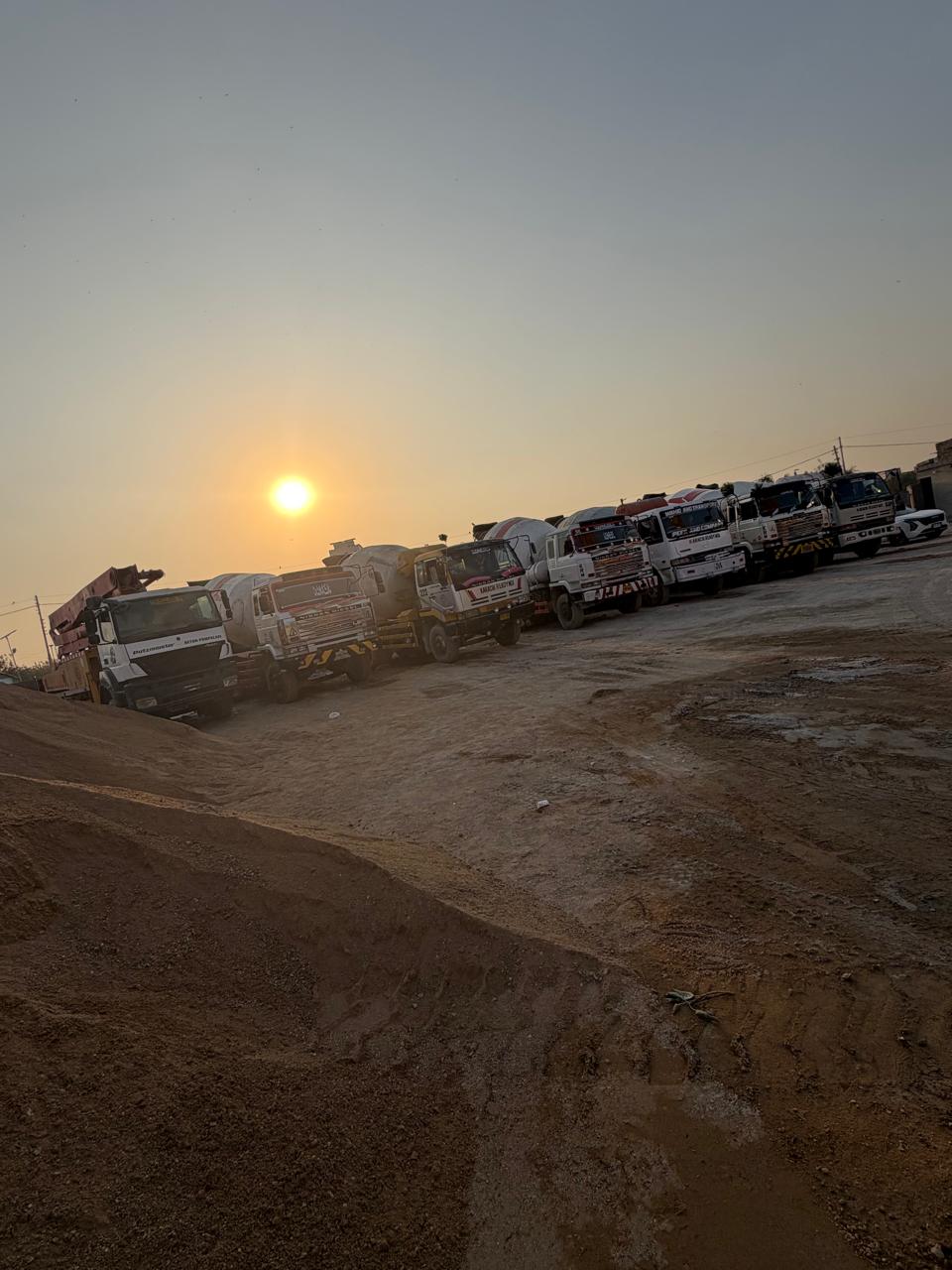 Wide view of concrete mixer fleet at sunset