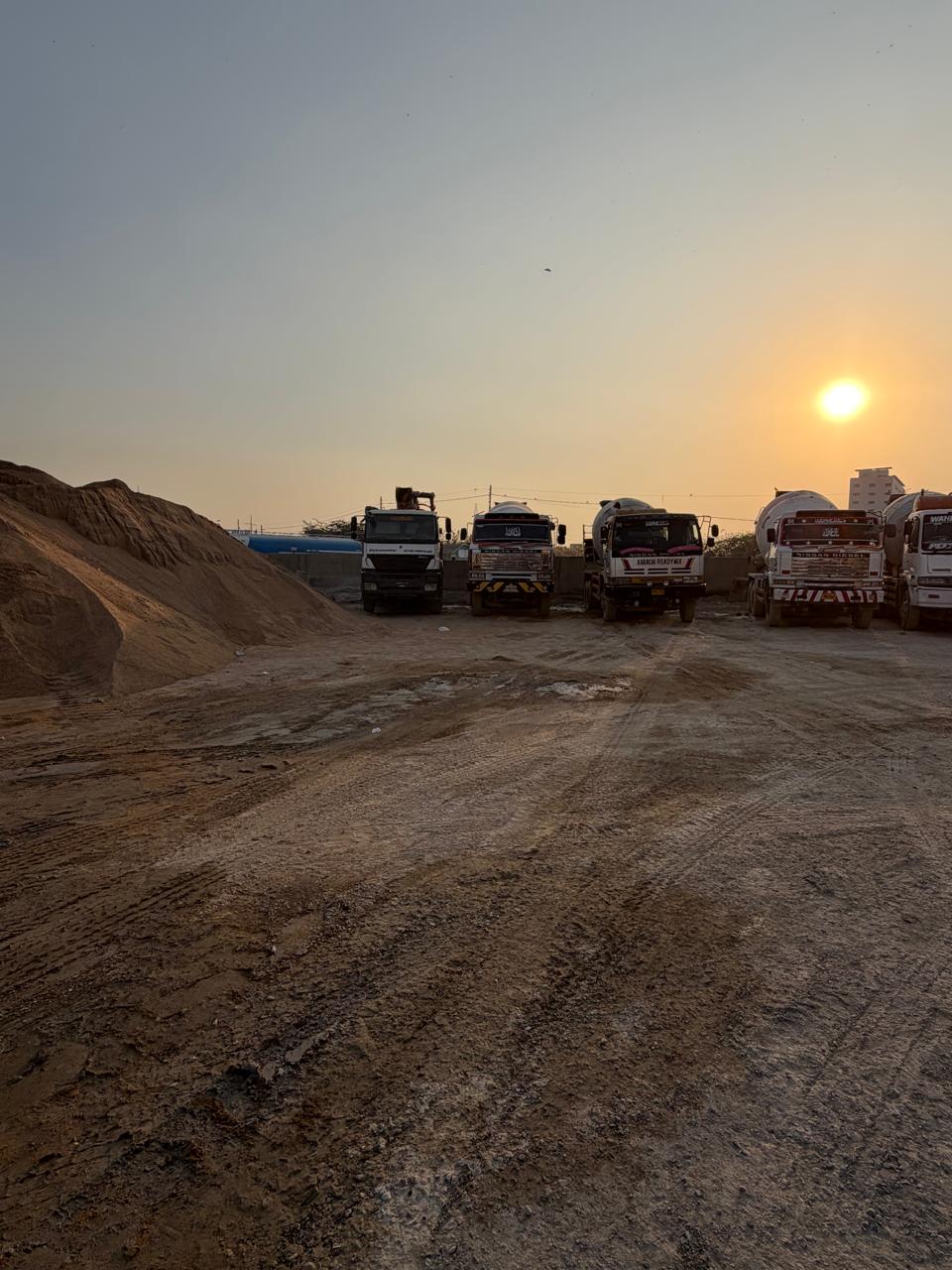 Mixer trucks parked at the KRM yard at sunset