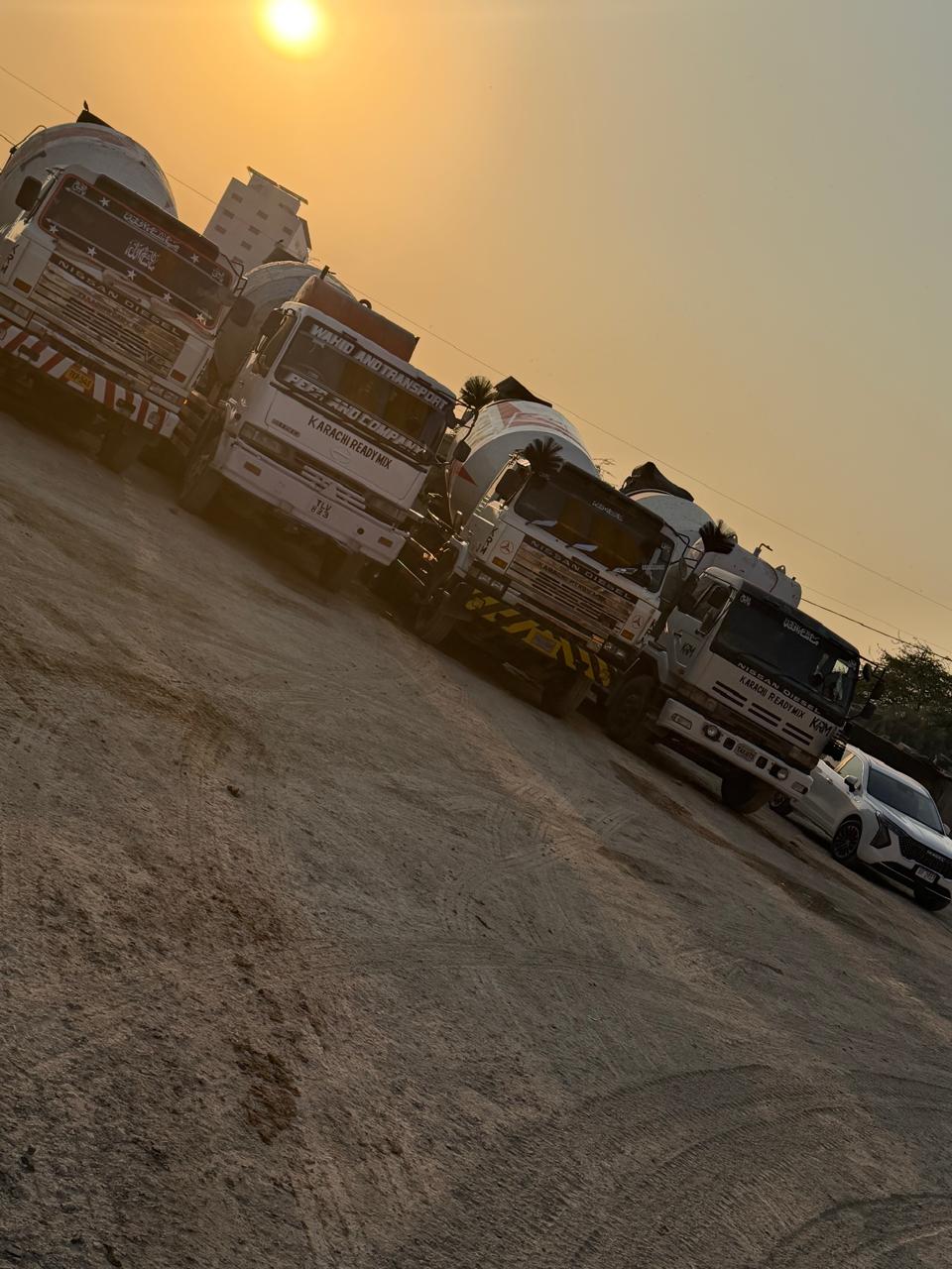 Line of Karachi Ready Mix trucks in the yard